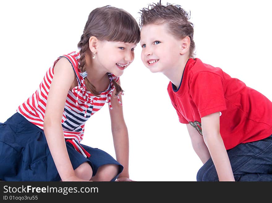 Brother and sister are playing on the floor in the studio