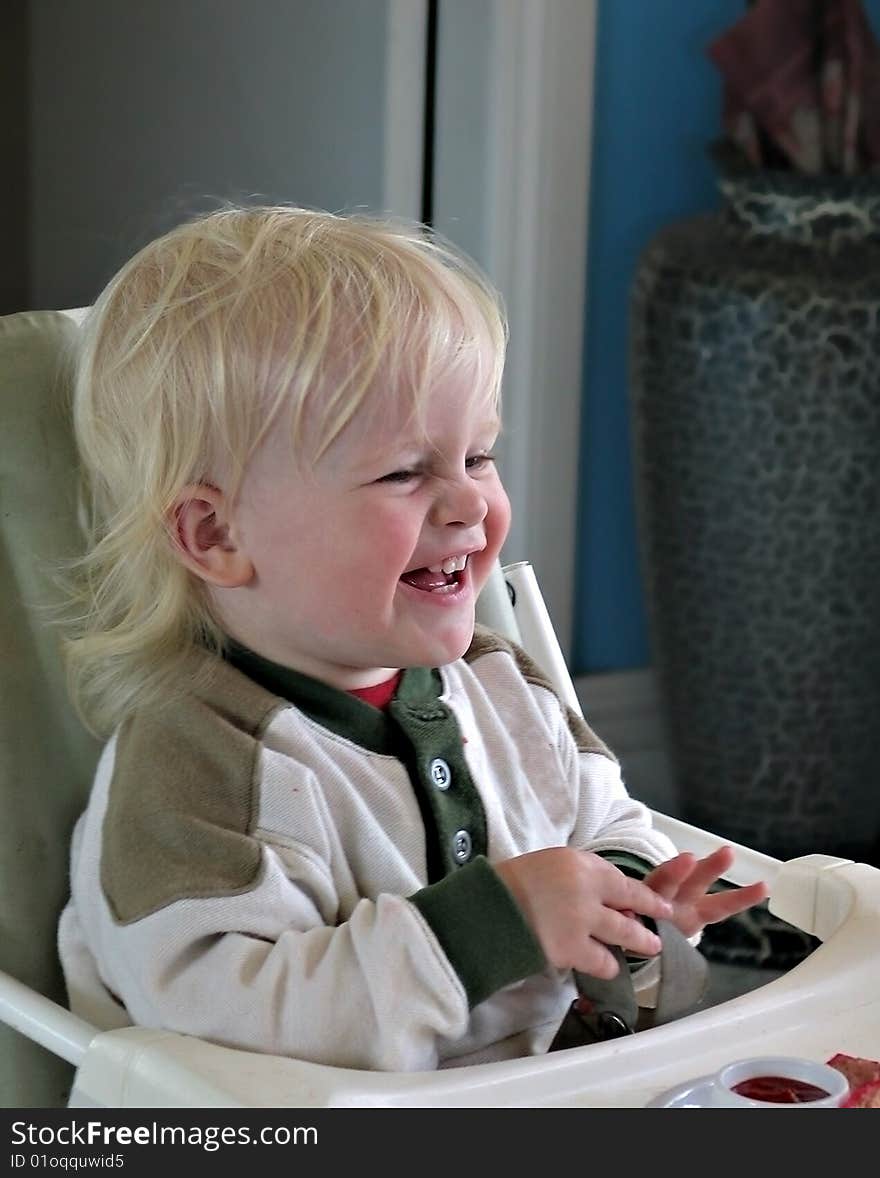 Little boy laughing and screwing up his face in happiness. Little boy laughing and screwing up his face in happiness