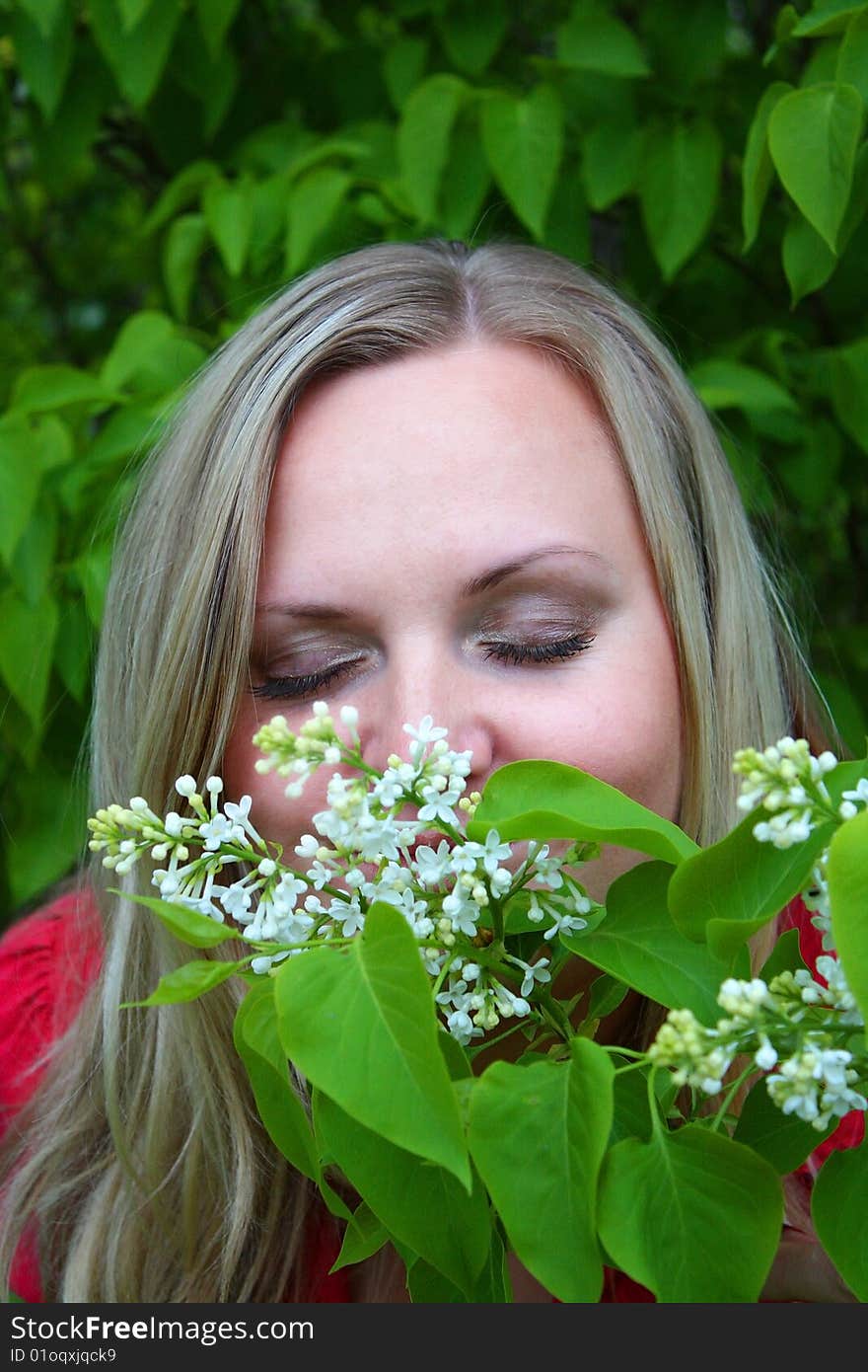 Young girl and blossoming lilac