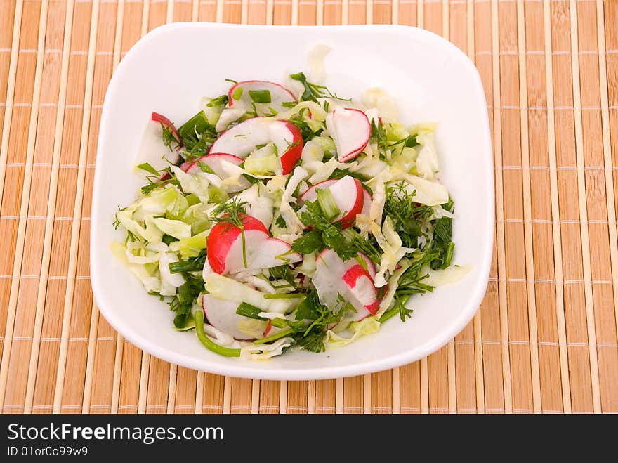 Fresh green salad with cabbage, a garden radish and greens