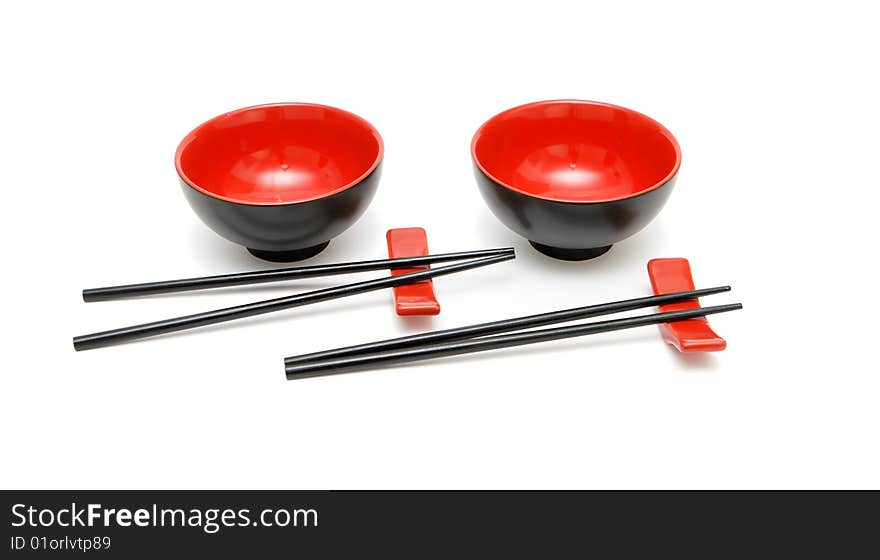 Two sets of chopsticks, stands and bowls