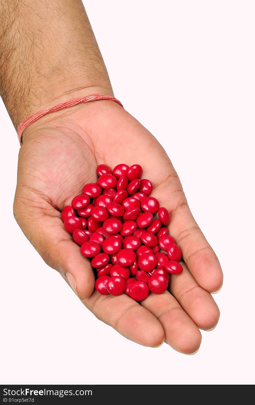 Red tablets on hand isolated on white