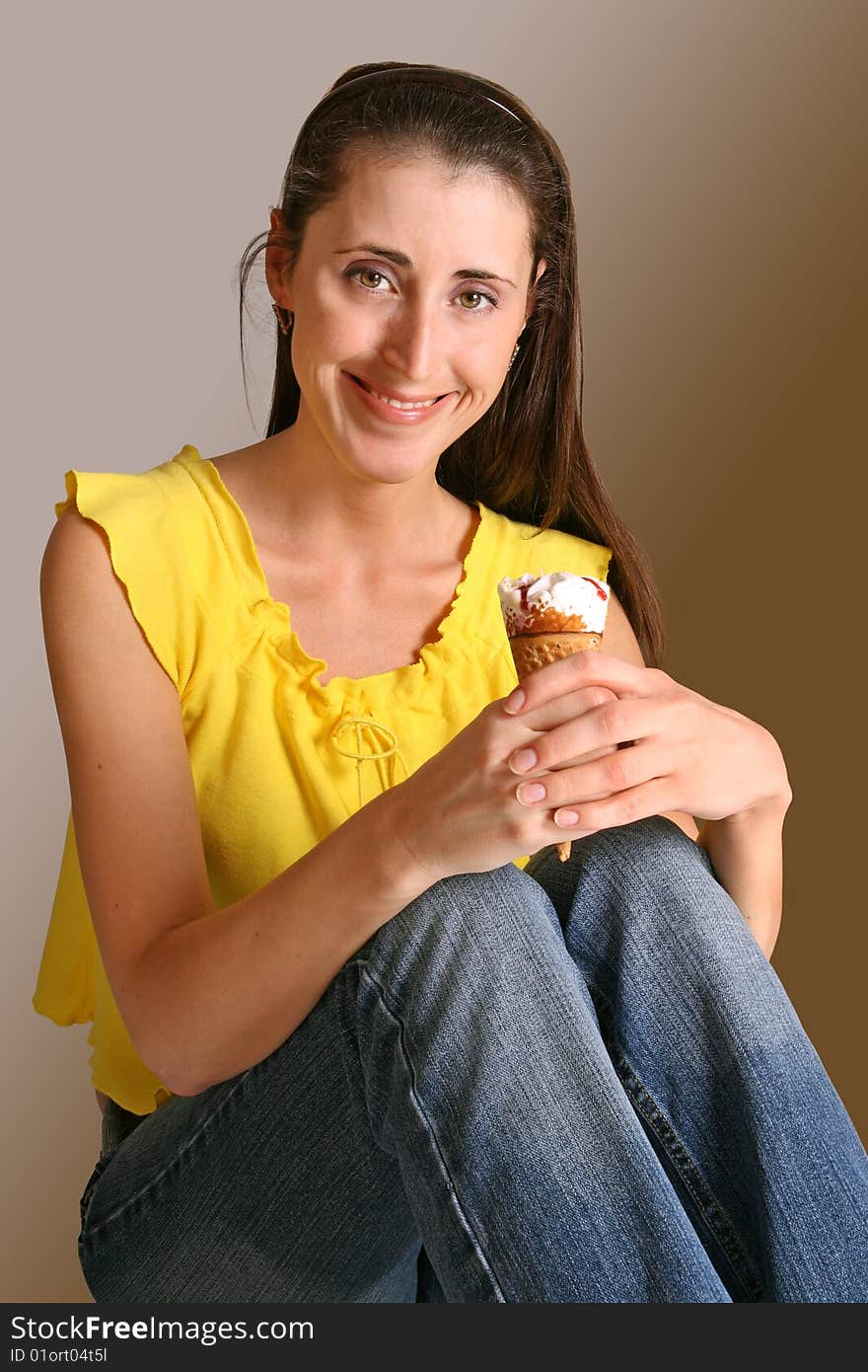 The girl eats ice cream cake in the wafer form. The girl eats ice cream cake in the wafer form