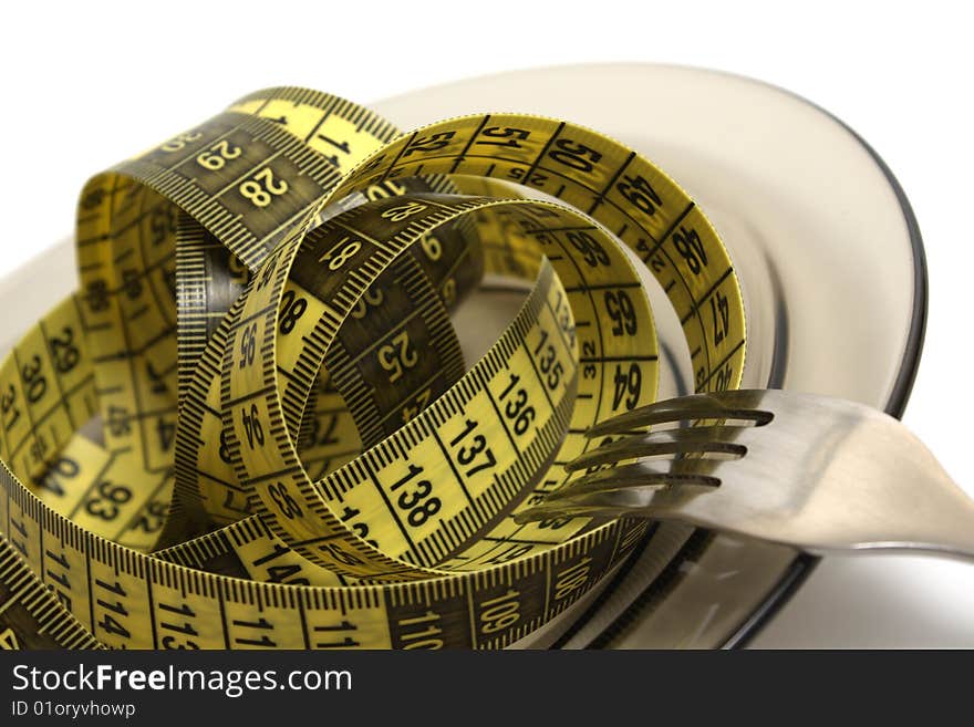 Plate and fork with measuring tape isolated on white. Plate and fork with measuring tape isolated on white