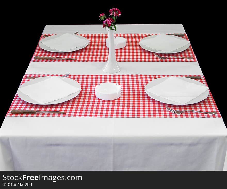 Plaits with silverware on table with red checked tablecloth. Plaits with silverware on table with red checked tablecloth