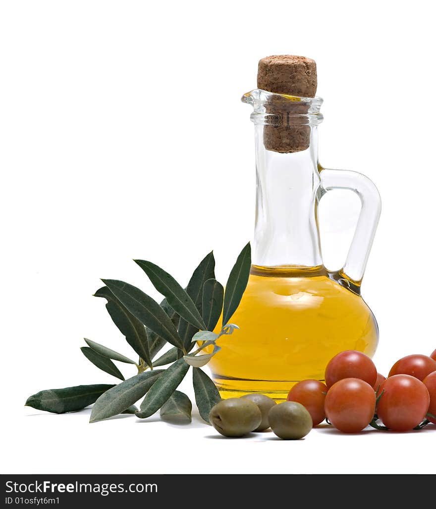 Bottle of olive oi, tomatoes, and olive fruits