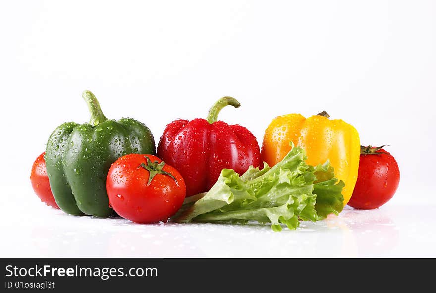 Fresh tomatoes and pepper on a white background. Fresh tomatoes and pepper on a white background