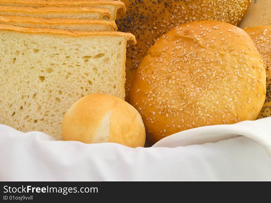 A variety of freshly baked breads in a basket. A variety of freshly baked breads in a basket