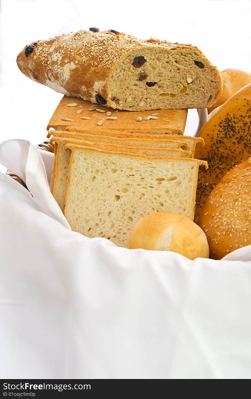 A variety of freshly baked breads in a basket. A variety of freshly baked breads in a basket