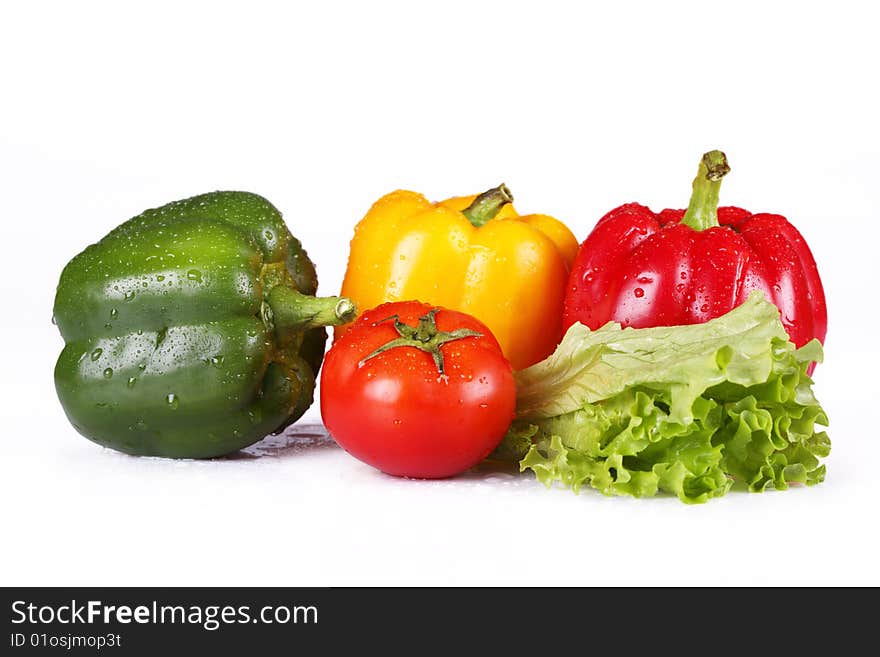 Fresh tomatoes and pepper on a white background. Fresh tomatoes and pepper on a white background