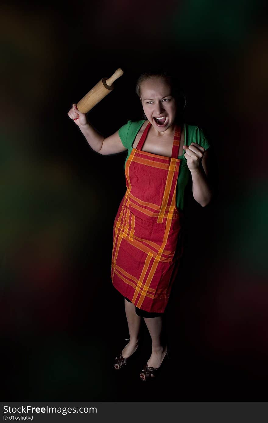 Woman with kitchen tool (rolling pin) - as angry wife