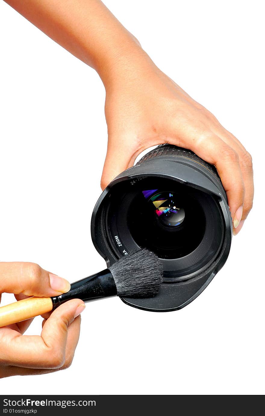 Female hands cleaning lens with brush.