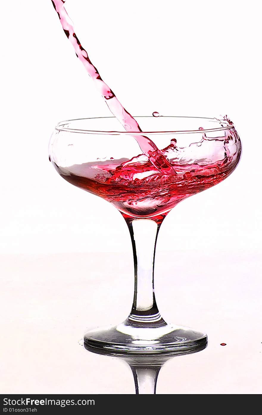 The wine flowing in a glass water  drop drops. The wine flowing in a glass water  drop drops