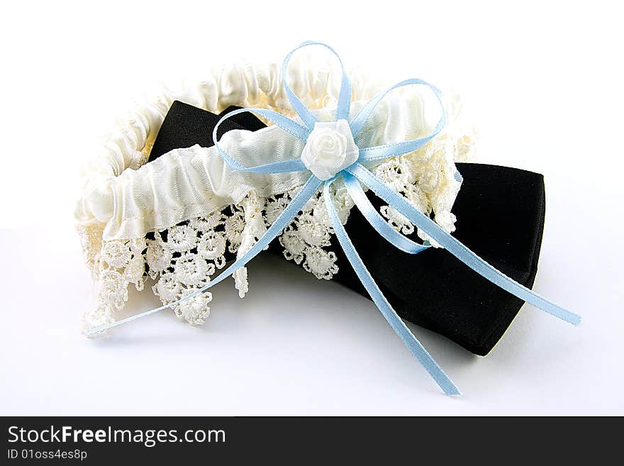 Black bow tie and white gartar with blue bow on a white background. Black bow tie and white gartar with blue bow on a white background