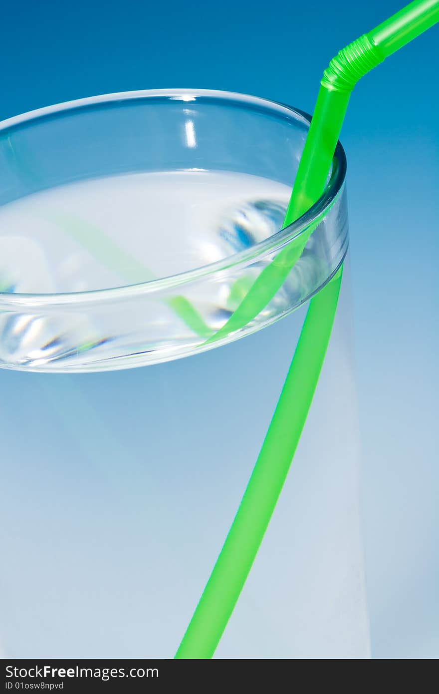 Glass of water on blue gradient background