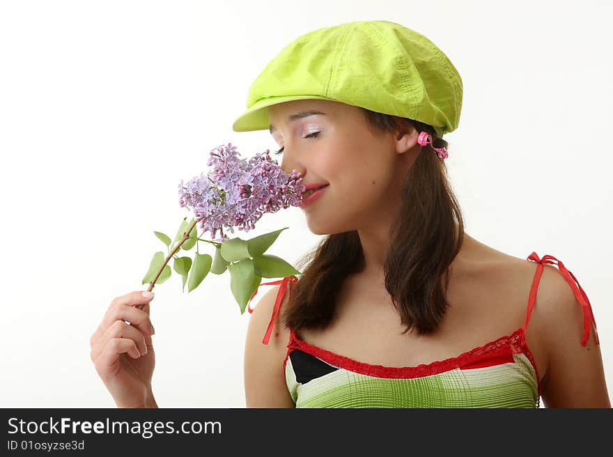 The girl in a green cap with a lilac bouquet