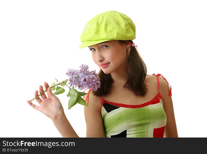 The girl in a green cap with a lilac bouquet