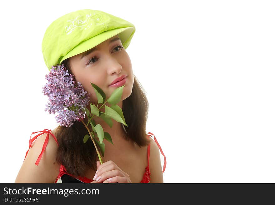 The girl in a green cap with a lilac bouquet