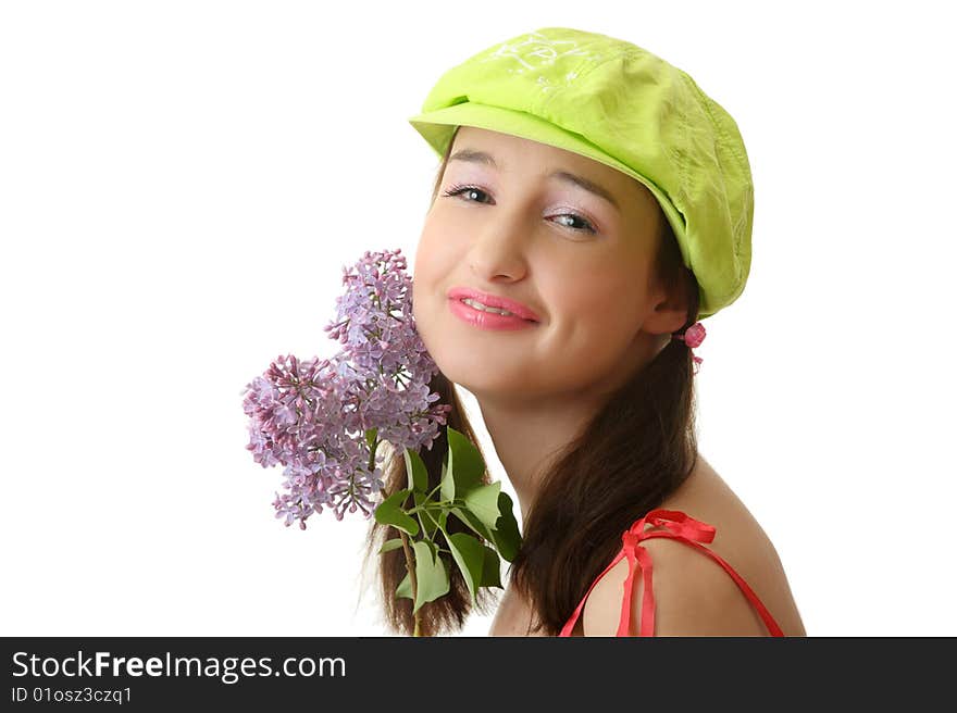 The girl in a green cap with a lilac bouquet