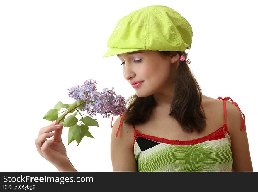 The girl in a green cap with a lilac bouquet