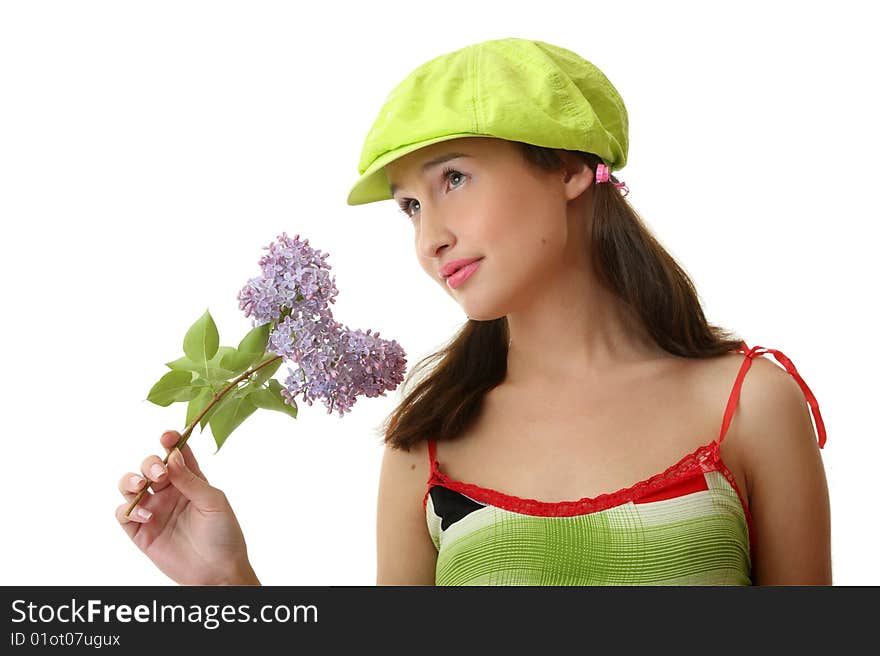 The girl in a green cap with a lilac bouquet