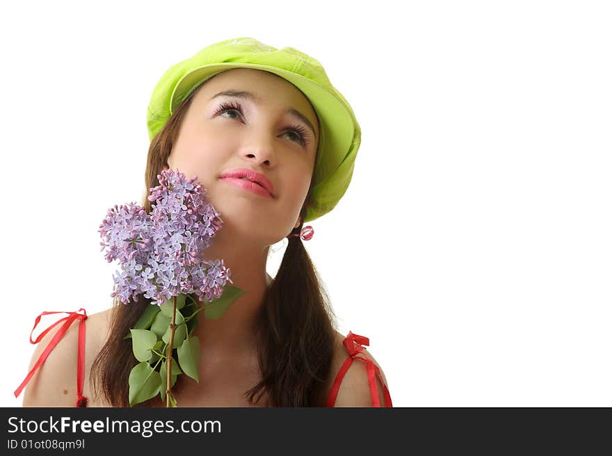 The girl in a green cap with a lilac bouquet