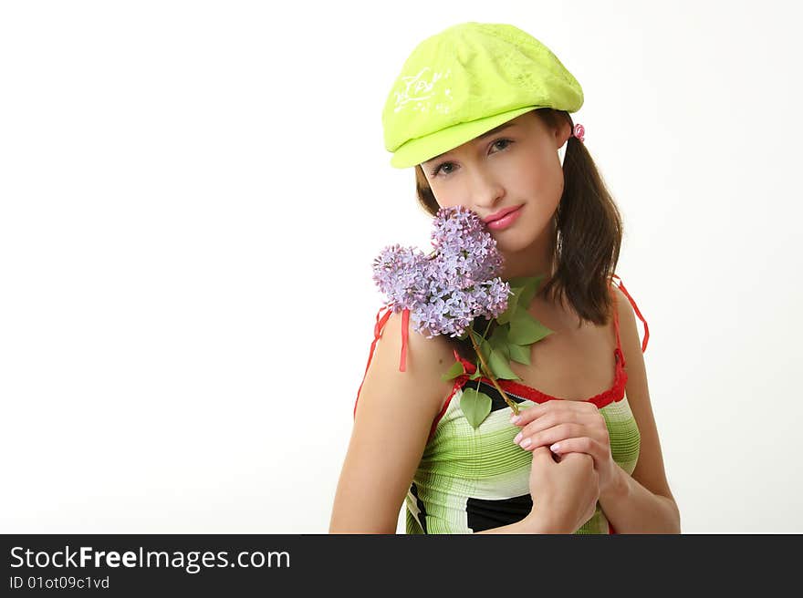 The girl in a green cap with a lilac bouquet