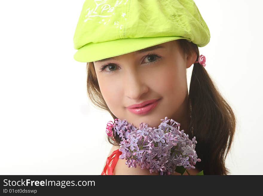 The girl in a green cap with a lilac bouquet