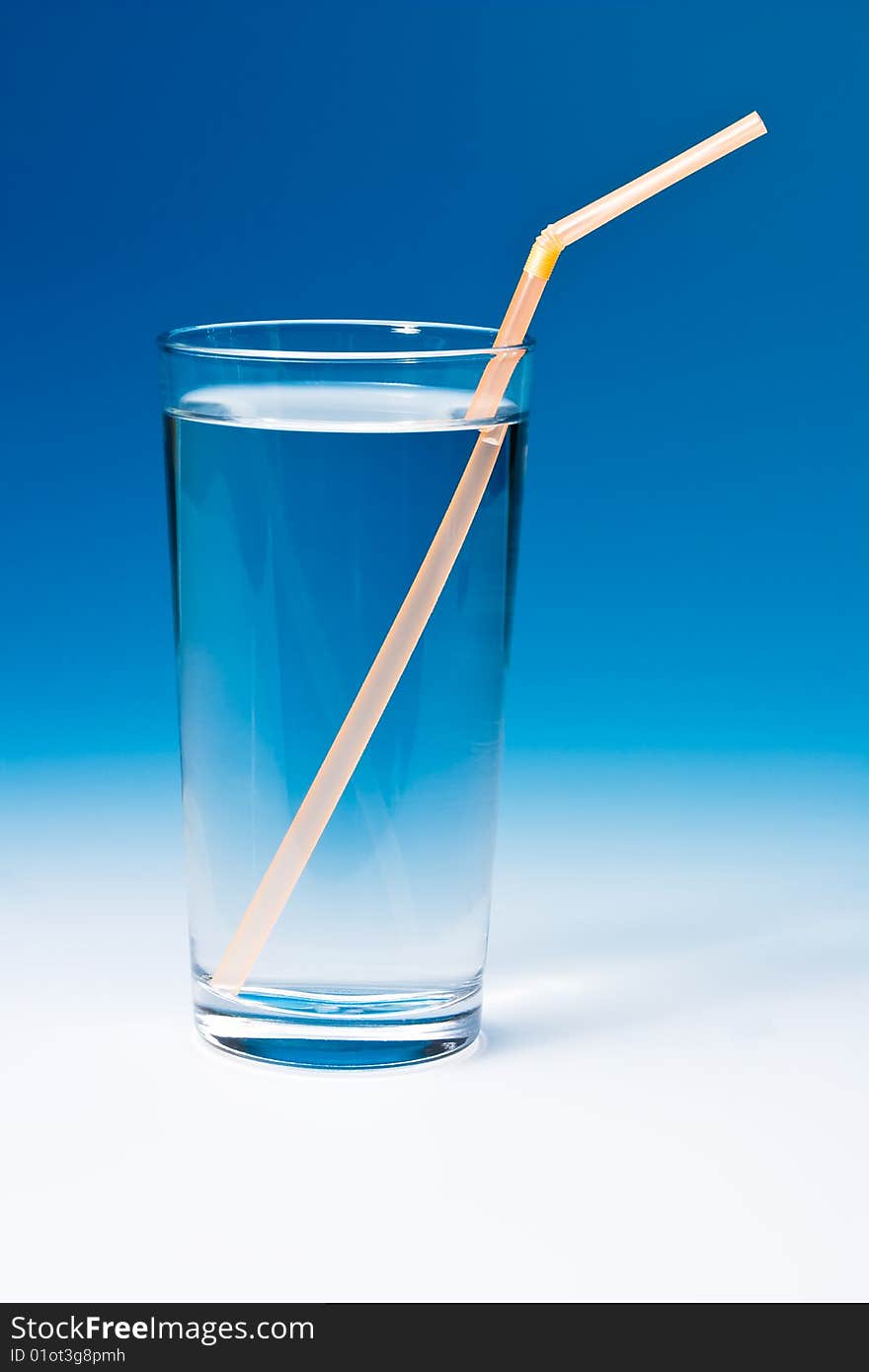 Glass of water on blue gradient background