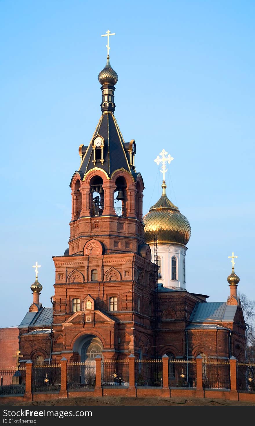 Church with golden cross on background blue sky