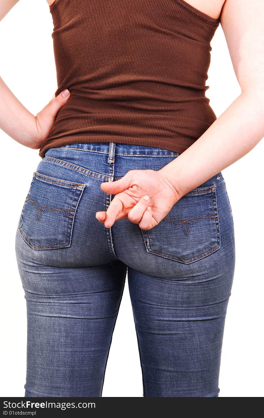 The back of a young girl, in a brown top and blue jeans, with the nice round and the right hand with the grossed fingers. The back of a young girl, in a brown top and blue jeans, with the nice round and the right hand with the grossed fingers.