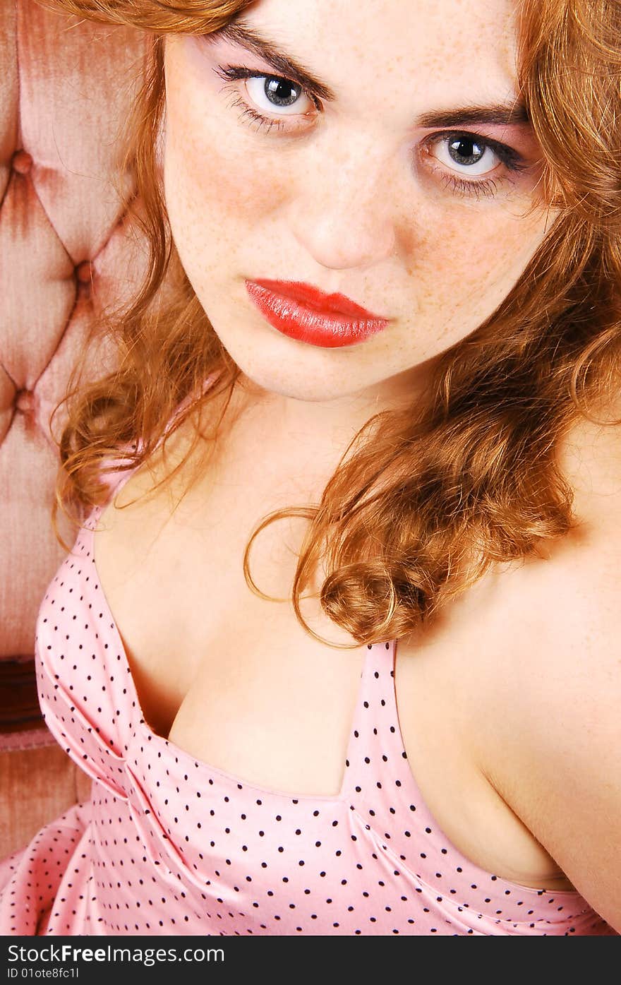 A young red haired woman sitting on a pink sofa in a pink dress
looking in the camera, view of the nice breasts. A young red haired woman sitting on a pink sofa in a pink dress
looking in the camera, view of the nice breasts.