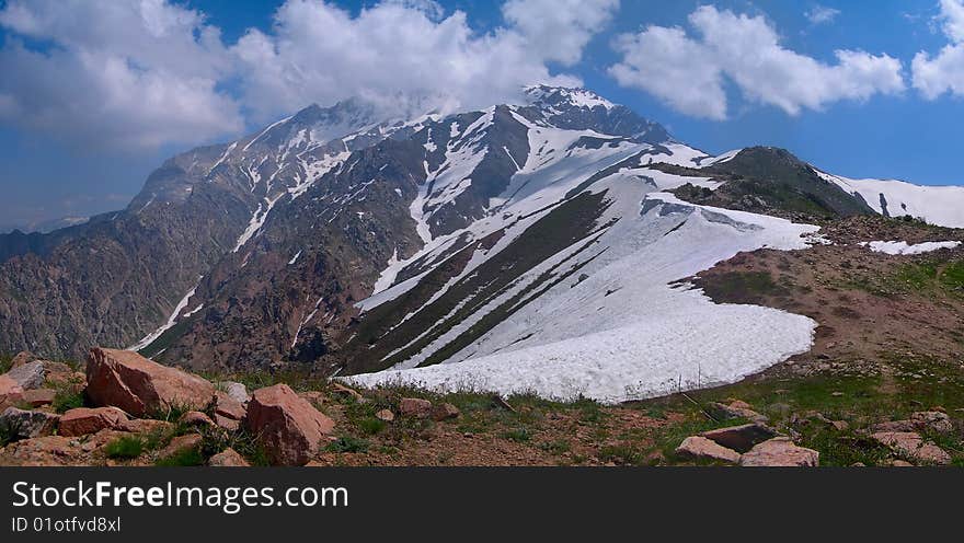 Mountain ridge to the peak under clouds. Mountain ridge to the peak under clouds