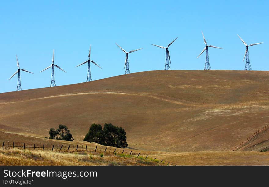 Power generating wind turbines on the field. Power generating wind turbines on the field