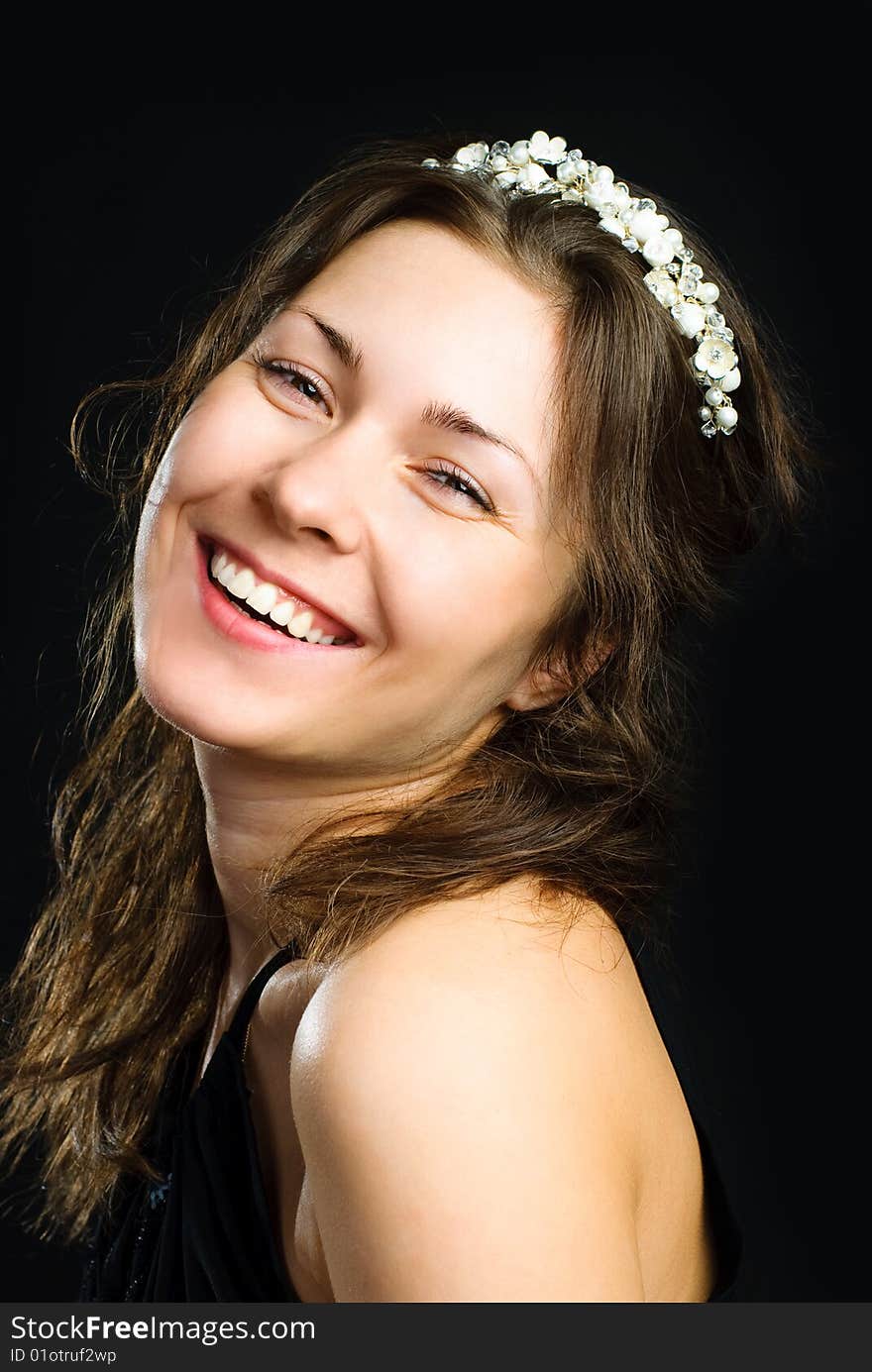 Studio portrait of a beautiful young brunette woman wearing a diadem. Studio portrait of a beautiful young brunette woman wearing a diadem