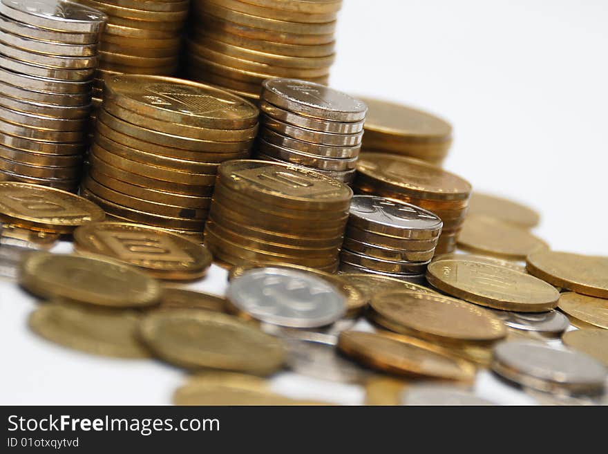 Different coins stacked on white background