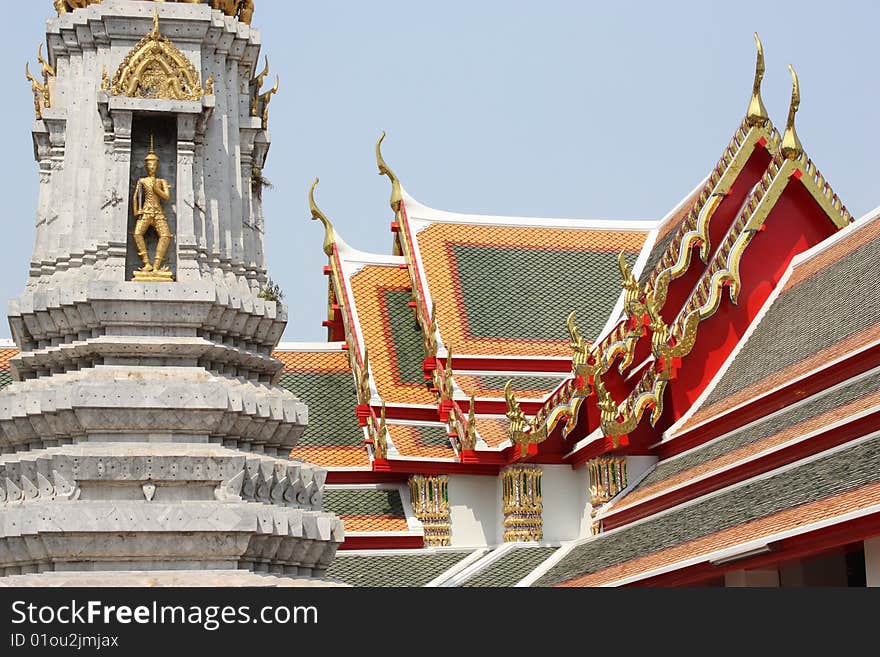 A detail in the famous Wat Pho buddhist temple in Bangkok, Thailland, featuring a gray stupa with a Buddha statue. A detail in the famous Wat Pho buddhist temple in Bangkok, Thailland, featuring a gray stupa with a Buddha statue.