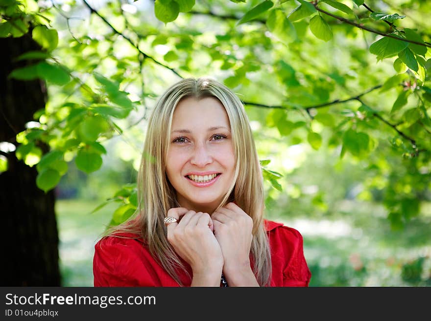 Portrait of woman in red dress in nature