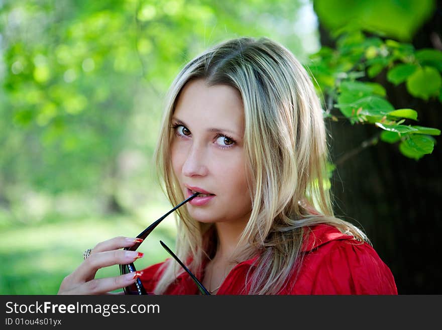 Portrait of woman in red dress in nature