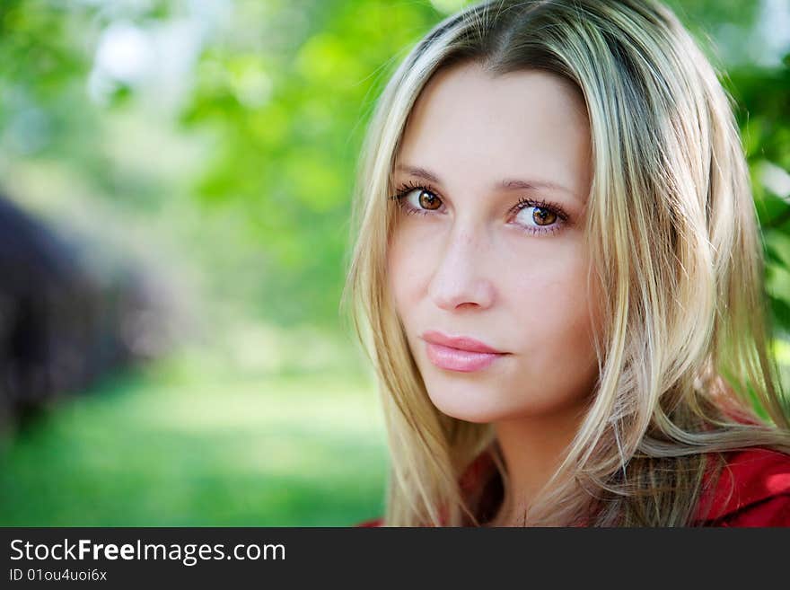 Portrait of woman in red dress in nature