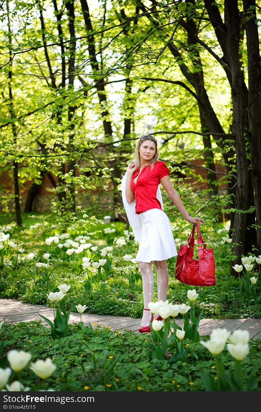 Portrait of woman in red dress in nature