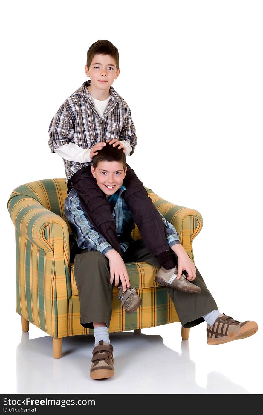 Two young happy smiling boys playing in the chair. Two young happy smiling boys playing in the chair