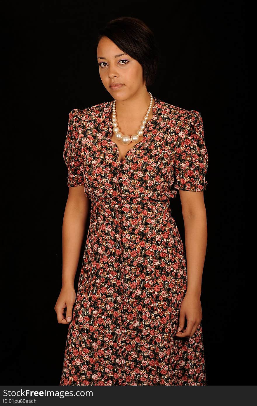 A closeup portrait of a pretty African American teenage woman. Black background. A closeup portrait of a pretty African American teenage woman. Black background