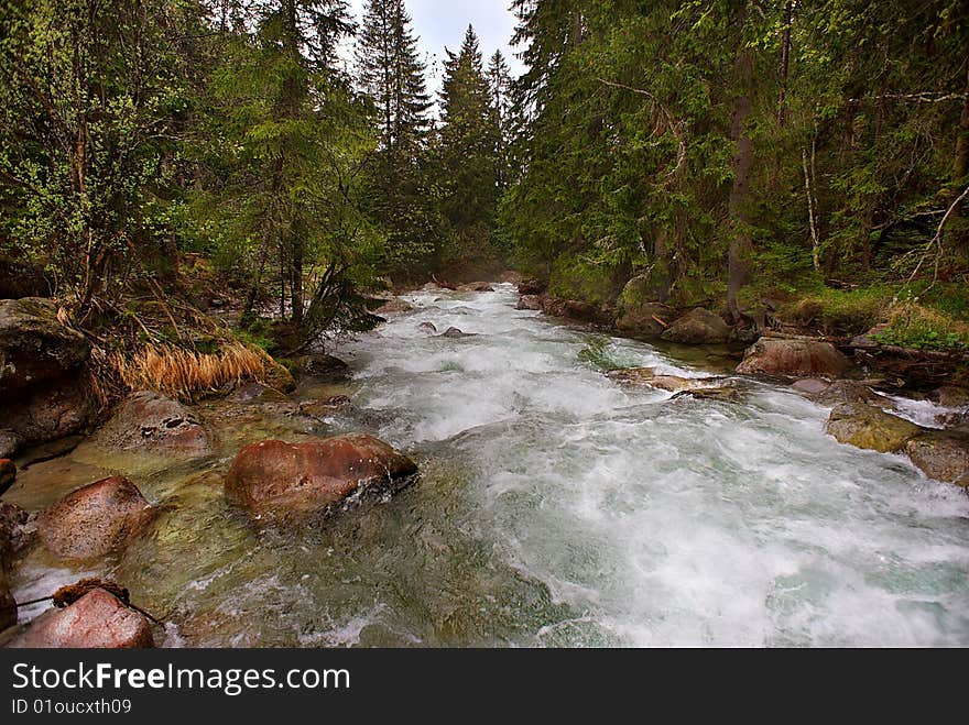 Mountain creek with red stones