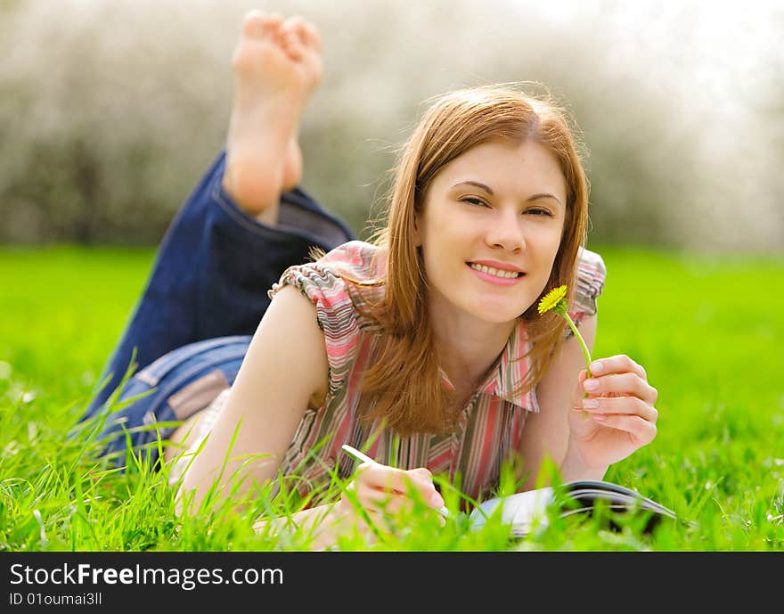 Beautiful smiling student studying outdoors