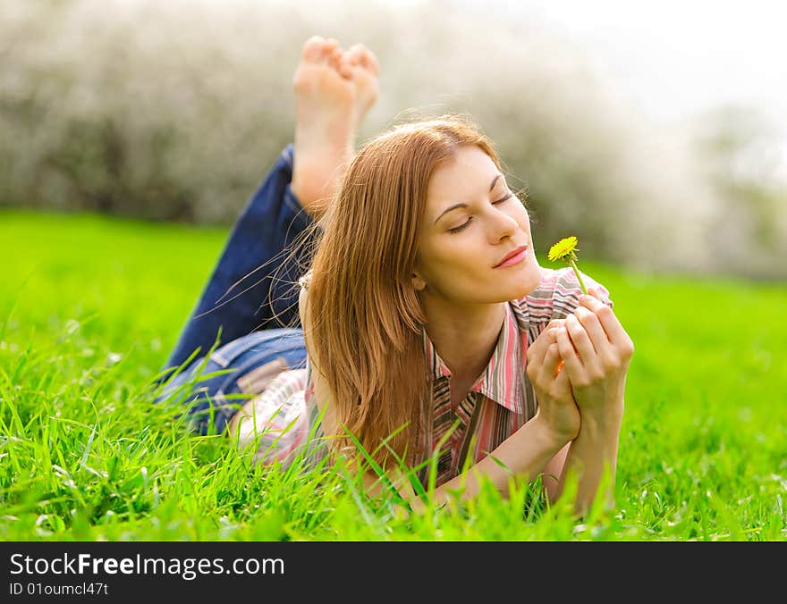 Attractive young woman relaxing outdoors. Attractive young woman relaxing outdoors