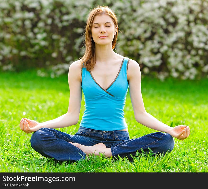 Beautiful woman meditating outdoors