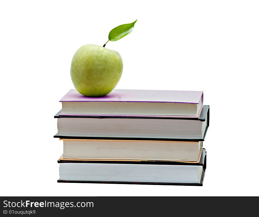 Green apple on pile of books on white background