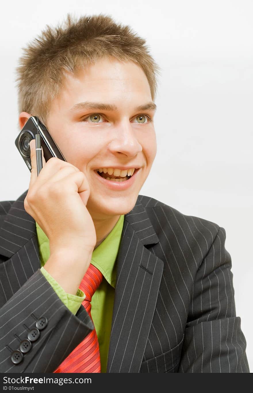 Young happy businessman talking on the cellphone. Young happy businessman talking on the cellphone