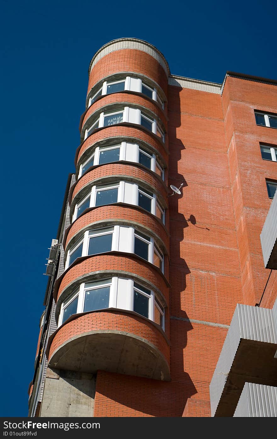 Modern apartment building against clear blue sky